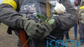 Ukrainian soldiers hold flowers as volunteer troops marry at Kyiv checkpoint