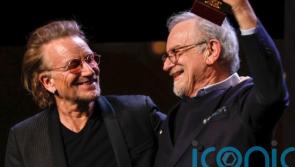 Bono presents legendary filmmaker with special award at film festival
