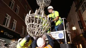 Workers begin hanging Christmas lights in Dublin City months before big day