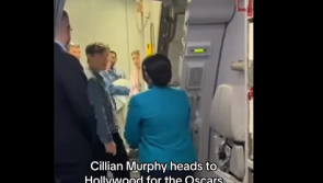 WATCH: Cillian Murphy poses for photos with flight staff as he heads for the Oscars