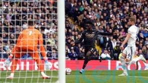 Bukayo Saka fires Arsenal to win as league leaders survive late scare at Leeds