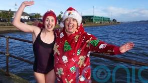 Hundreds of plucky swimmers brave chilly sea for charity