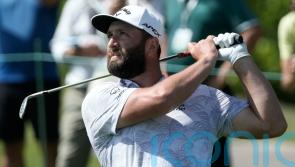Jon Rahm shoots course record as title defence hots up