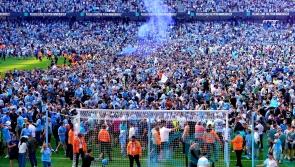 Manchester City players and fans celebrate step one of the treble