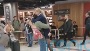 Crowd cheers as man proposes to flight attendant in Dublin Airport