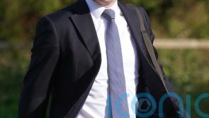 Opposition parties call on Donnelly to return from NY amid spinal surgery review