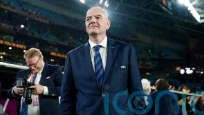 FIFA president Gianni Infantino shows the red card to blue cards