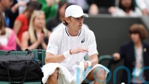 Alex De Minaur reaches first Wimbledon quarter-final but suffers injury scare