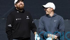 Open day three: Rory McIlroy supporting leader Shane Lowry after missing the cut