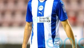 Wigan hold nerve in penalty shootout to see off Barrow