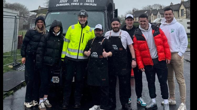 Hurlers Darragh O'Donovan and Kyle Hayes (far right) with presenter Baz Ashwany in high-vis working on the DIY SOS project