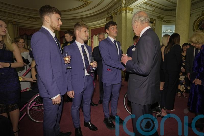 King makes a splash with Olympic stars at palace reception