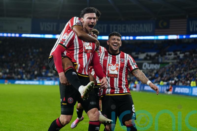 Kieffer Moore&rsquo;s double at Cardiff maintains Sheffield United&rsquo;s three-point lead