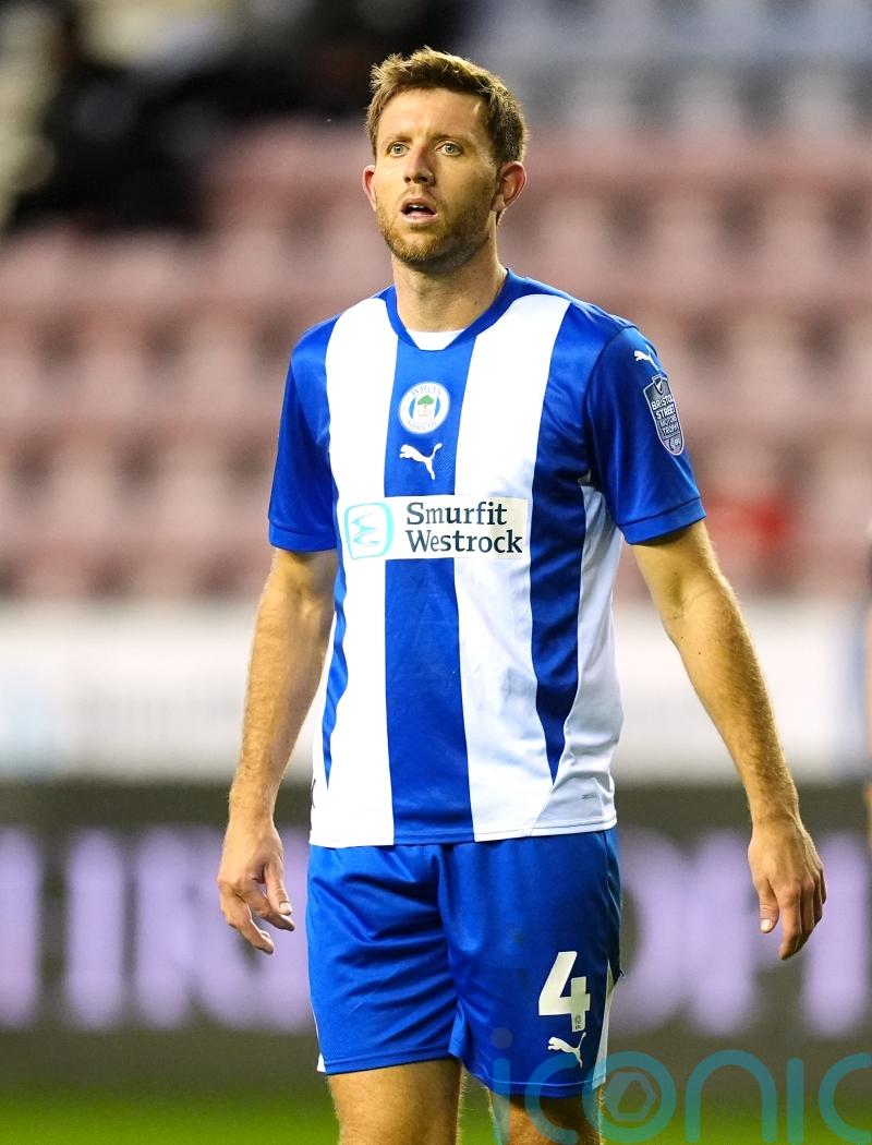 Wigan hold nerve in penalty shootout to see off Barrow